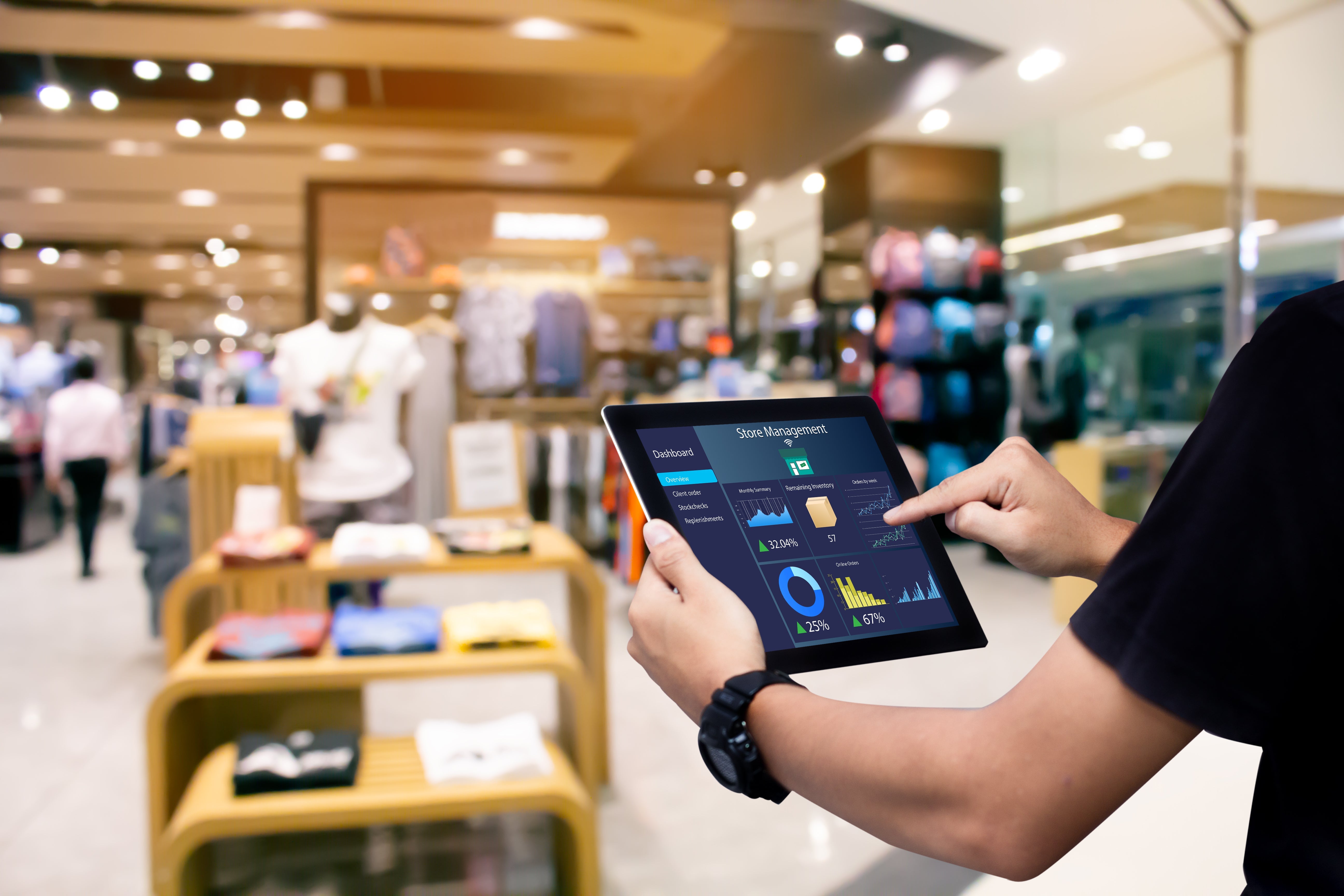 Man holding a tablet in Retail Shopping Store
